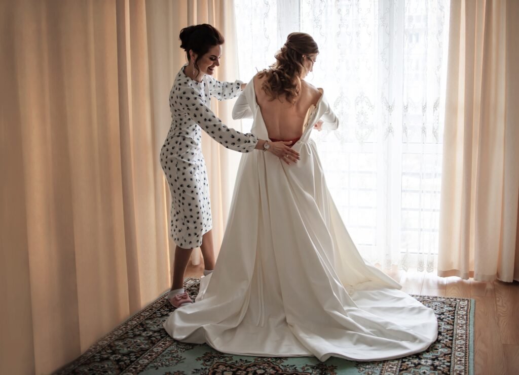 Wedding day. Bride putting on a wedding dress. Wedding dress